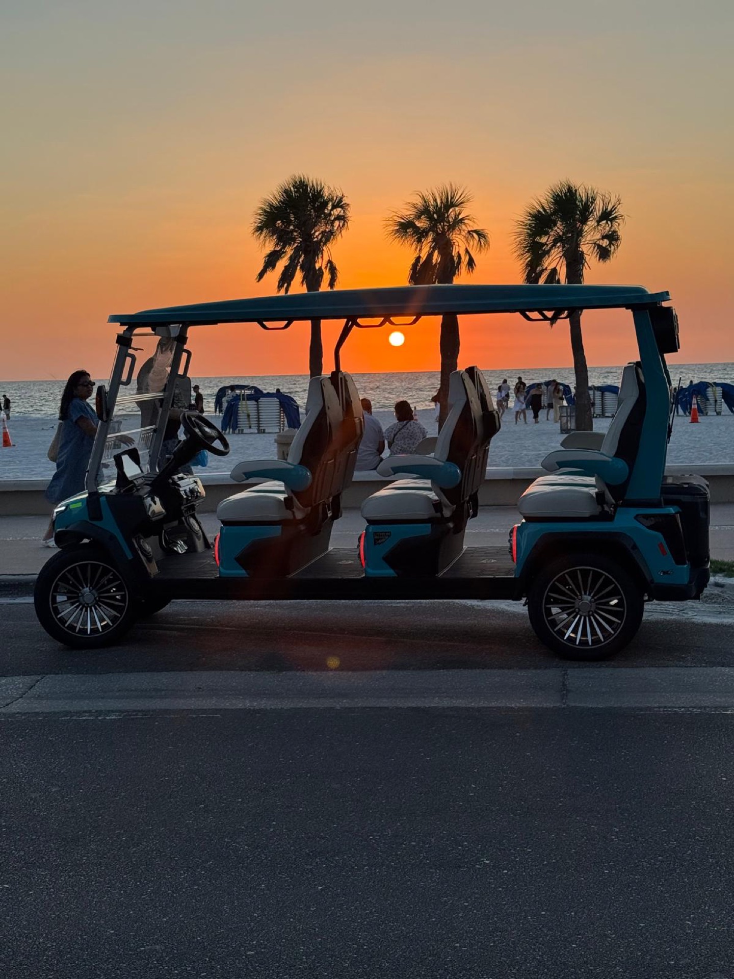 Cart against Clearwater sunset palms